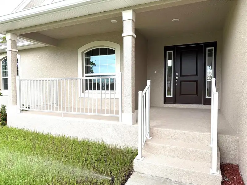 Front exterior of a new home in Rotonda, Rotonda West, FL, highlighting curb appeal (Image 16).