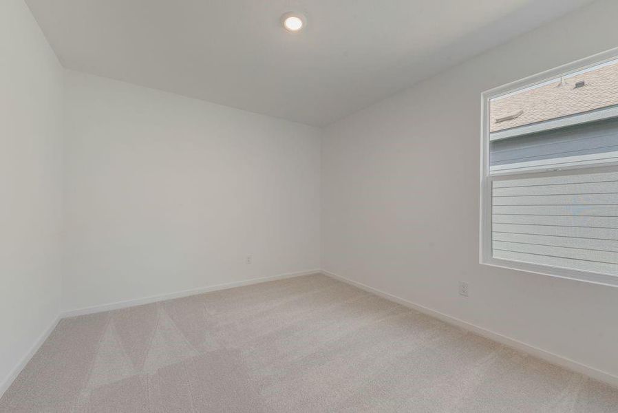Empty room featuring light carpet and recessed lighting