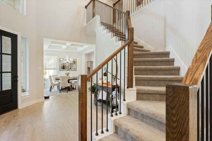 Entrance foyer featuring light wood-style flooring and a high ceilings