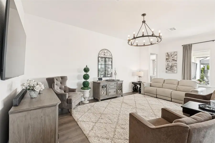 High ceilings and rich wood flooring anchor this welcoming living area.