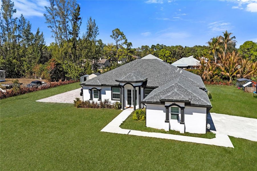 Front exterior of a new home in , Loxahatchee, FL, highlighting curb appeal (Image 32).
