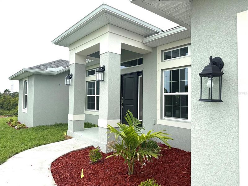 Front exterior of a new home in South Gulf Cove, Port Charlotte, FL, highlighting curb appeal (Image 1).