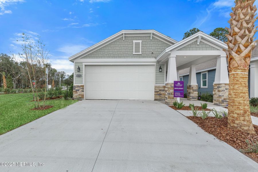 Front exterior of a new home in Magnolia Series at Seminole Palms, Palm Coast, FL, highlighting curb appeal (Image 1).