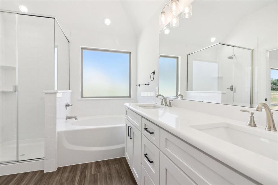 Bathroom with independent shower and bath, vanity, vaulted ceiling, and hardwood / wood-style flooring