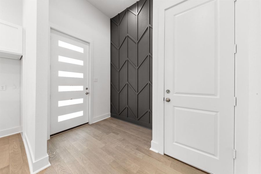 Bright entryway featuring beautiful engineered hardwood floors that add warmth and elegance from the moment you step inside.