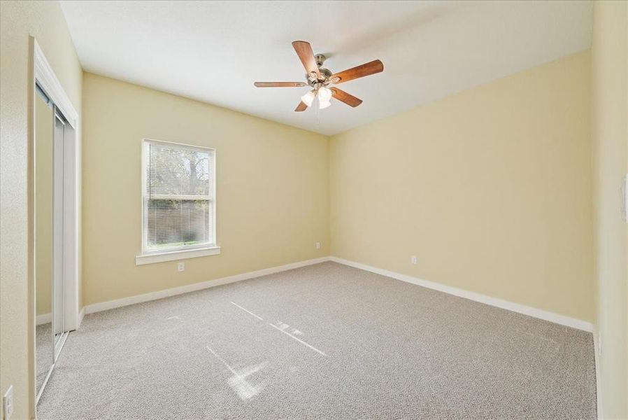 Unfurnished bedroom featuring carpet floors, a ceiling fan, and a closet