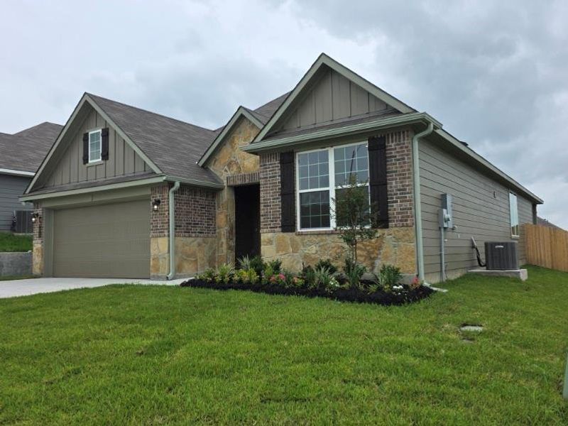 Front exterior of a new home in Vintage Farms, Brenham, TX, highlighting curb appeal (Image 2). Front exterior of a new home in Vintage Farms, Brenham, TX, highlighting curb appeal (Image 2).