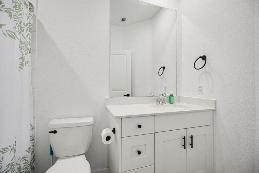 Secondary bathroom featuring a vanity with storage, updated fixtures, and a tub/shower combination. Secondary bathroom featuring a vanity with storage, updated fixtures, and a tub/shower combination.