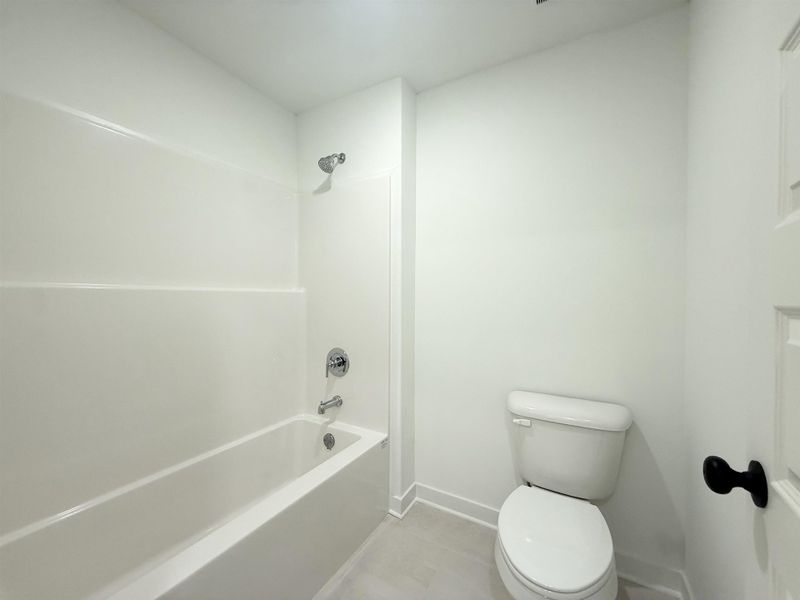 Bathroom featuring shower / washtub combination and light tile patterned flooring