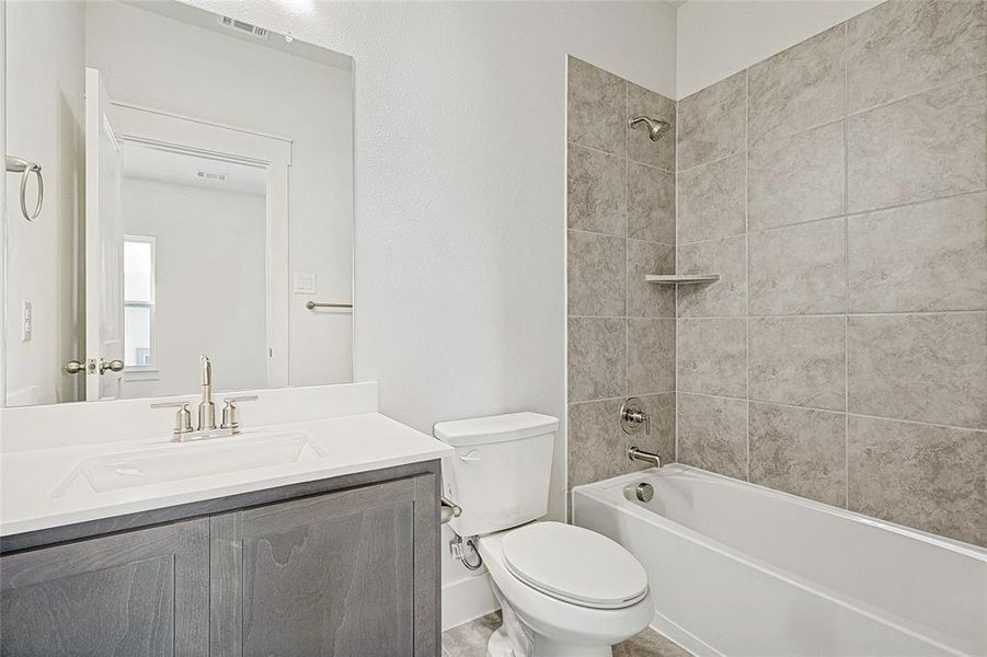 Bathroom with vanity and bathtub / shower combination