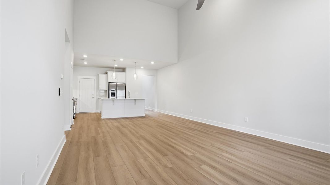 Refined and memorable, this family room features two-story ceilings and top-notch comfort throughout