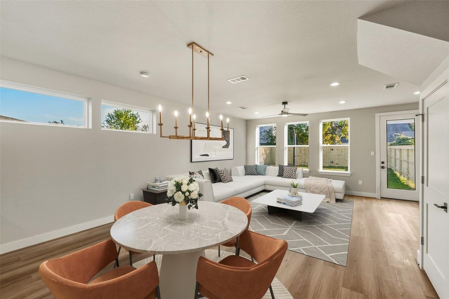 Experience the perfect blend of dining and living in this spacious, light-filled room, featuring ample windows and a stunning backyard view, perfect for a large sectional.