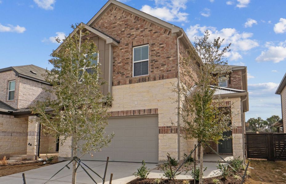 Front exterior of a new home in Horizon Lake, Leander, TX, highlighting curb appeal (Image 25). Front exterior of a new home in Horizon Lake, Leander, TX, highlighting curb appeal (Image 25).