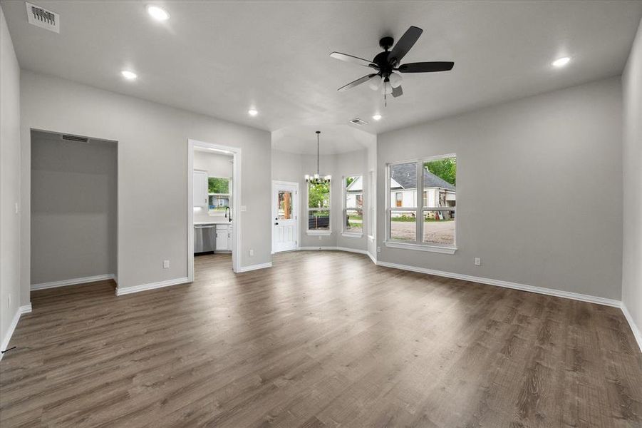 Spacious living area featuring wood-finish flooring, recessed lighting, and a ceiling fan