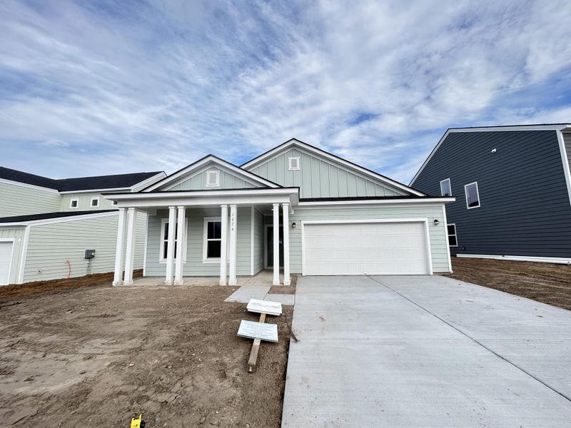 Front exterior of a new home in Tea Farm, Ravenel, SC, highlighting curb appeal (Image 1). Front exterior of a new home in Tea Farm, Ravenel, SC, highlighting curb appeal (Image 1).