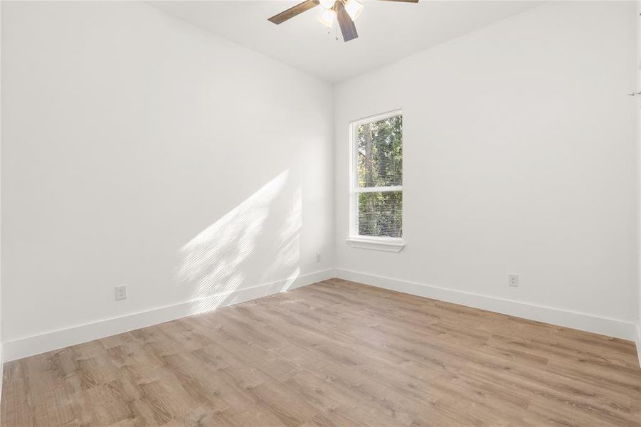 Empty room featuring ceiling fan and light hardwood / wood-style floors