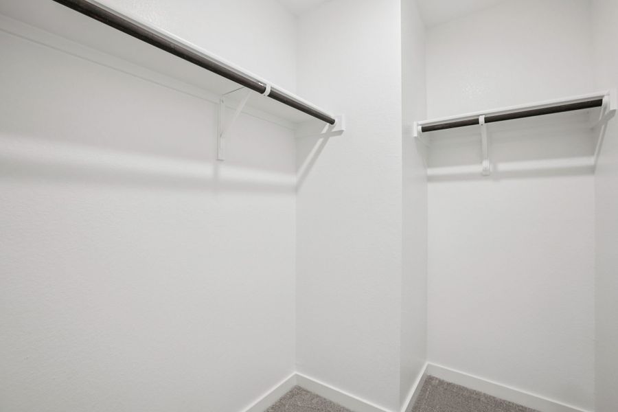 A white wall with a metal bar.