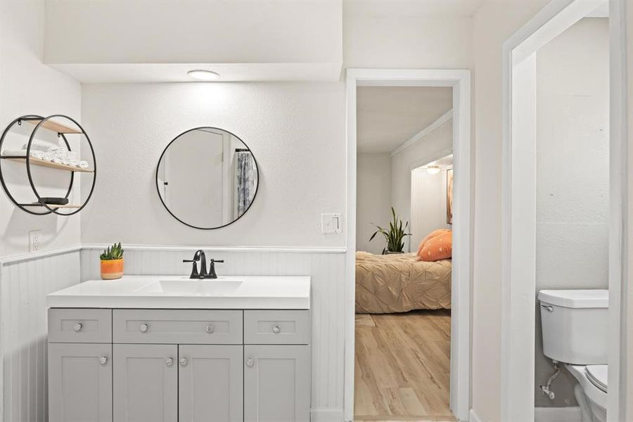 Bathroom featuring vanity, toilet, and hardwood / wood-style flooring