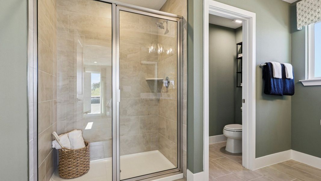The Mangrove Model Primary Bath with Walk-in Shower at Lakeside at Satilla by DRB Homes in Saint Cloud, FL