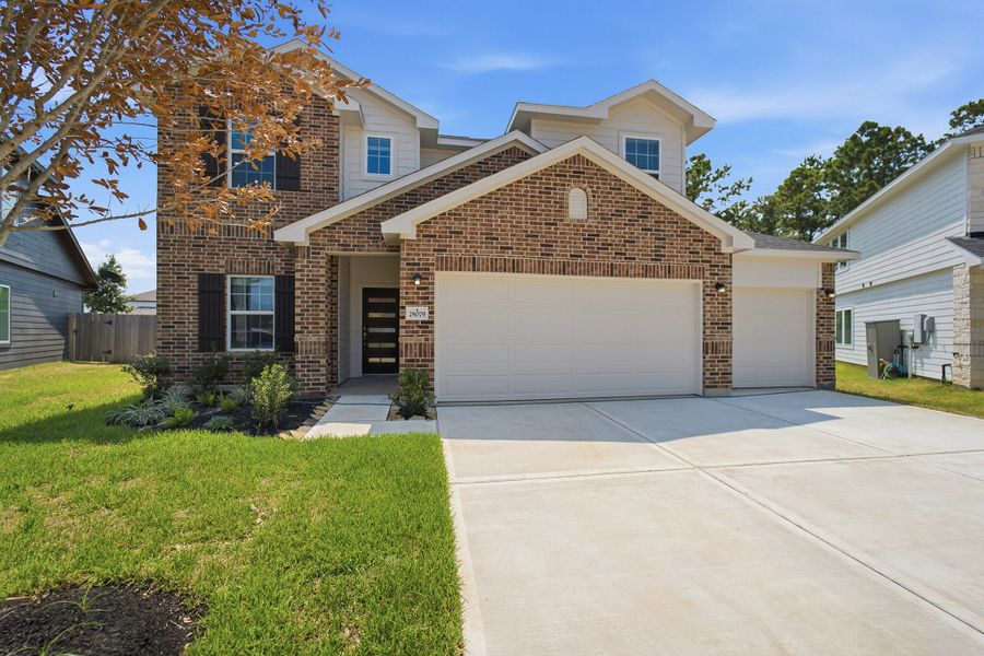 Front exterior of a new home in Magnolia Springs, Montgomery, TX, highlighting curb appeal (Image 2).