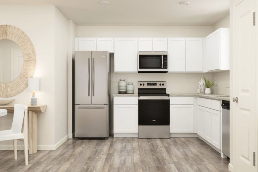 A kitchen with white cabinets.