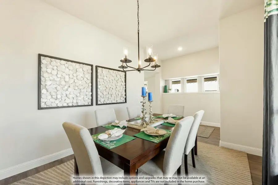 Dining room with dark wood table, six gray chairs, chandelier, and wall art panels