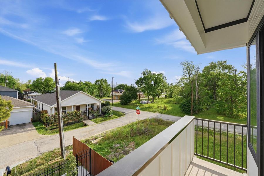 Private second-story balcony offering peaceful neighborhood views, lush green surroundings, and fresh open-air space—perfect for morning coffee or evening relaxation.