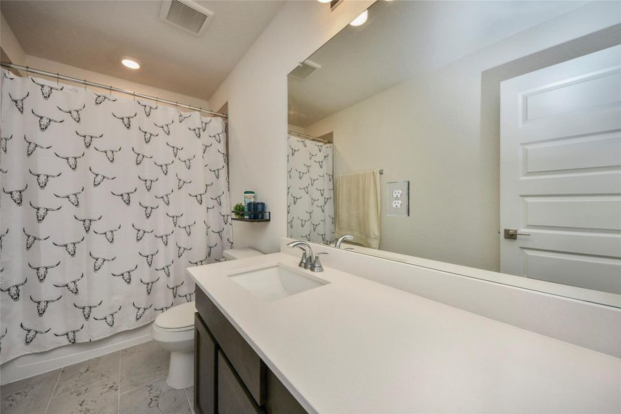 Furnished interior view inside a new home in Sunterra North, Katy (Image 7).