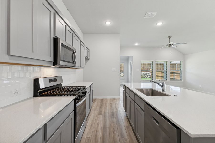 Kitchen in the Quartz home plan by Trophy Signature Homes – REPRESENTATIVE PHOTO