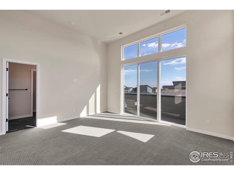 Sun Soaked Primary Bedroom w/ 12 Foot Ceilings and Private Deck