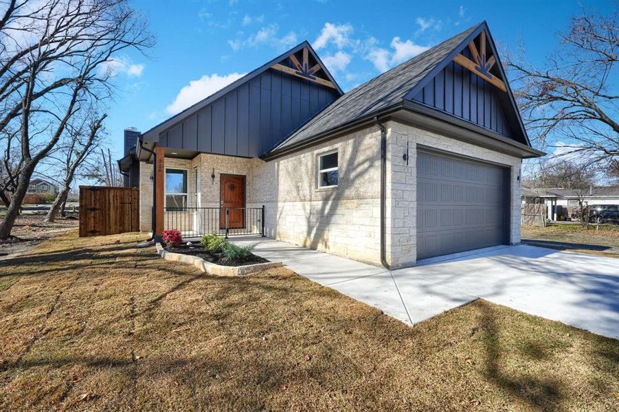 View of front of home featuring a garage and a front lawn