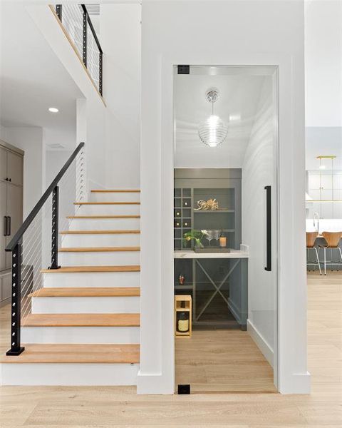Bar area featuring wood finished floors and stairway