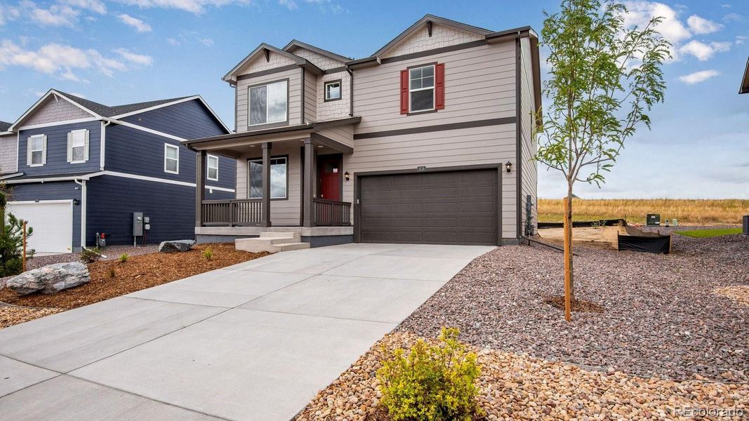Front exterior of a new home in Sky Ranch, Watkins, CO, highlighting curb appeal (Image 2).