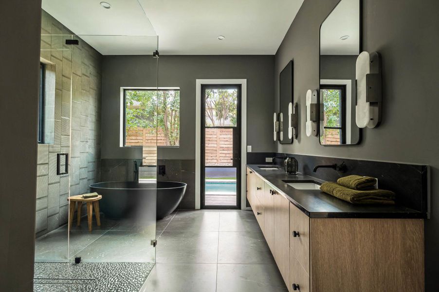 Bathroom featuring a huge walk in shower with rain shower head, freestanding bath, double vanity with LED light