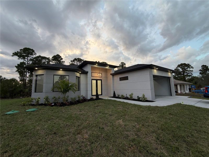 Front exterior of a new home in , Lehigh Acres, FL, highlighting curb appeal (Image 24).