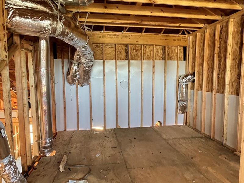 Unfinished storage room located next to the upstairs loft