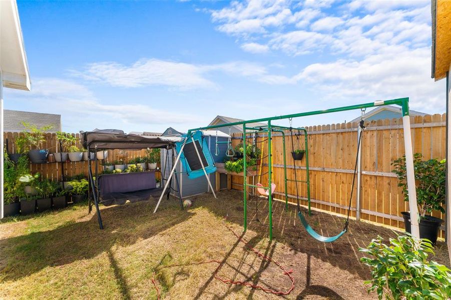 Fenced backyard featuring a playground Fenced backyard featuring a playground