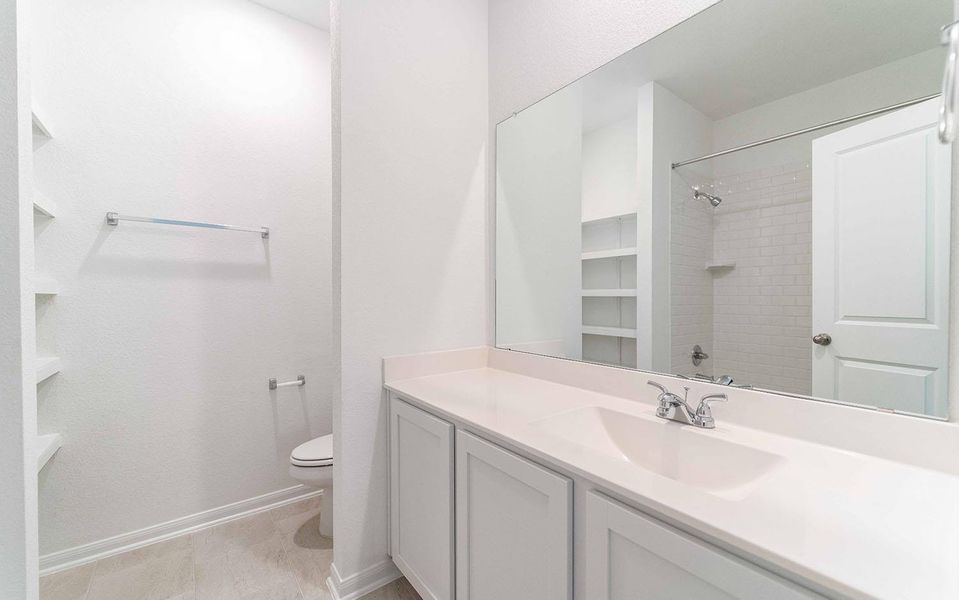 Bathroom featuring vanity and a shower Bathroom featuring vanity and a shower