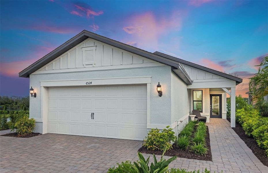 Front exterior of a new home in Reagan Landing, Bradenton, FL, highlighting curb appeal (Image 1). Front exterior of a new home in Reagan Landing, Bradenton, FL, highlighting curb appeal (Image 1).
