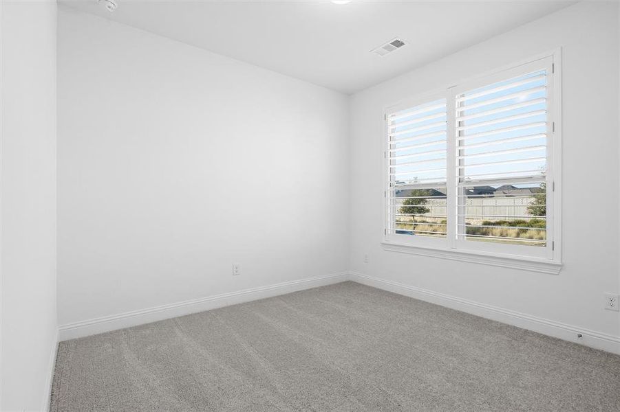 View of carpeted spare room