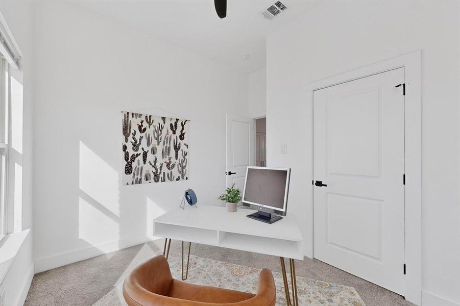 Office area with carpet floors and ceiling fan