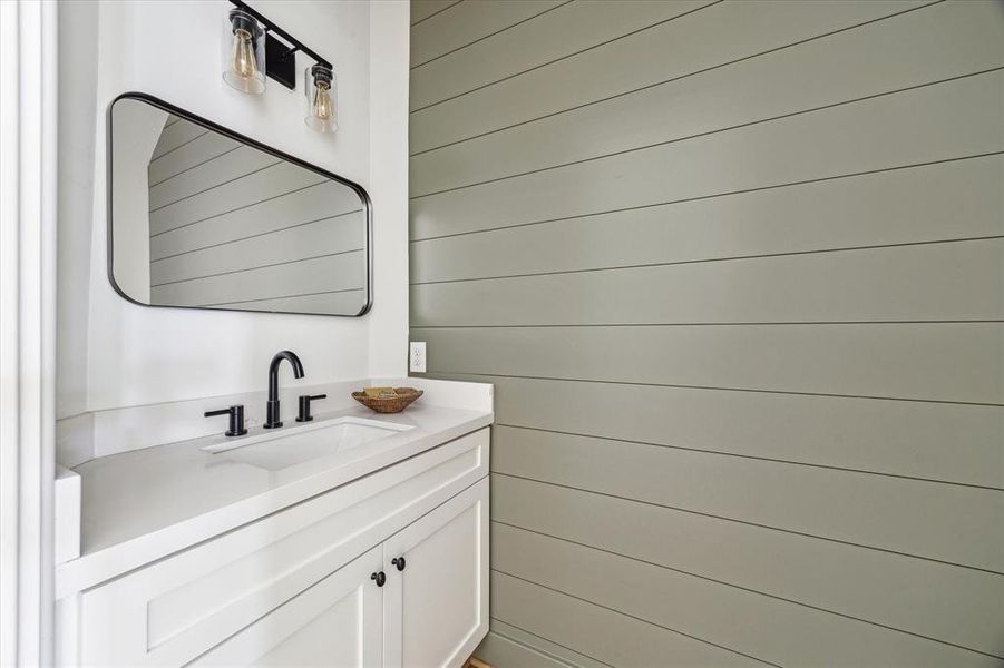 Half Bath with shiplap wall.