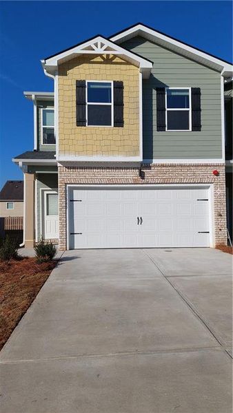 Front exterior of a new home in The Enclave Townhomes, Hampton, GA, highlighting curb appeal (Image 1). Front exterior of a new home in The Enclave Townhomes, Hampton, GA, highlighting curb appeal (Image 1).