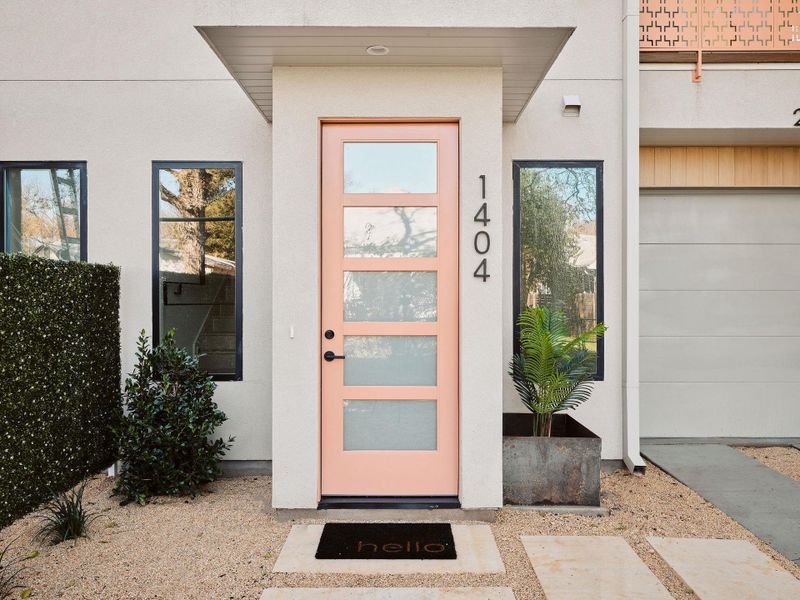 Modern home with an attached garage, stucco siding, and driveway