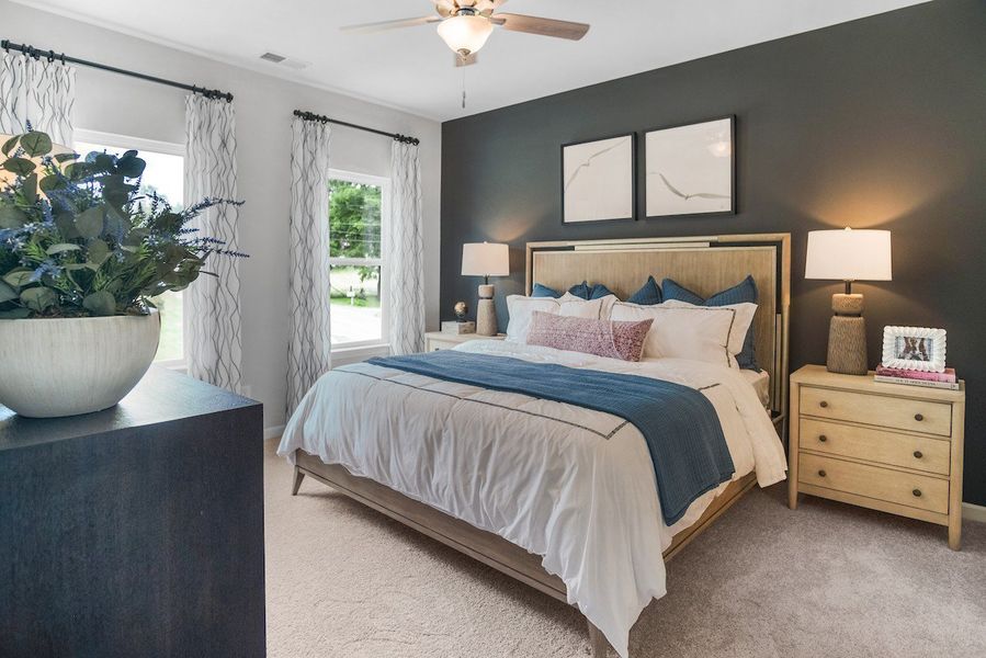Primary Bedroom-This picture is from our furnished and decorated model home in the community.  Window placement and color scheme may vary per unit location.  Ask agent for more specific details regarding color and options