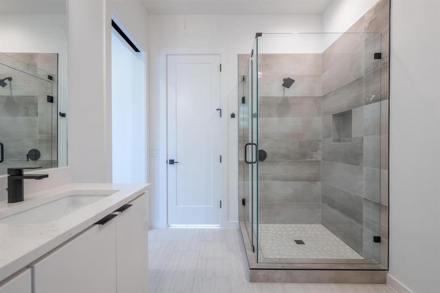 Bathroom featuring vanity and an enclosed shower