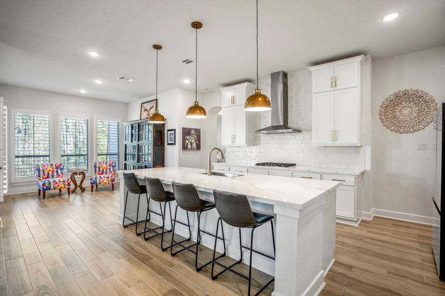 The open layout flows into the living area, and neighbors the breakfast room, ideal for entertaining.