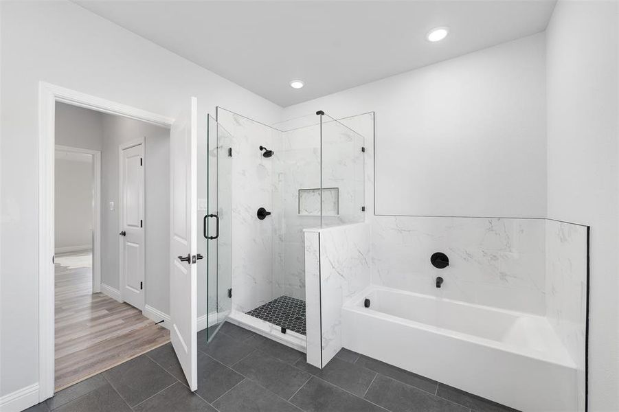 Bathroom with tile patterned flooring and plus walk in shower