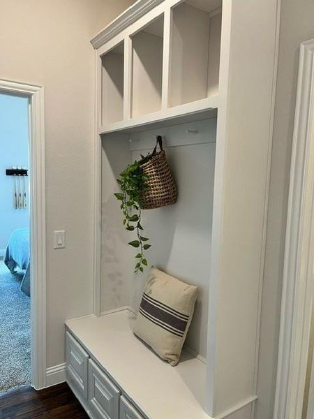 Mudroom with dark wood-style floors and baseboards Mudroom with dark wood-style floors and baseboards