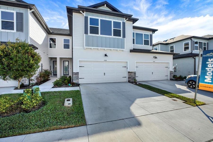 Front exterior of a new home in The Towns At Long Bayou, Seminole, FL, highlighting curb appeal (Image 2). Front exterior of a new home in The Towns At Long Bayou, Seminole, FL, highlighting curb appeal (Image 2).